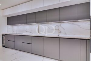 Kitchen with marble splashback and contemporary cabinetry