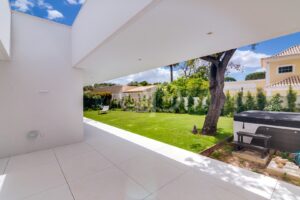 Covered terrace overlooking lawn and mature landscaping