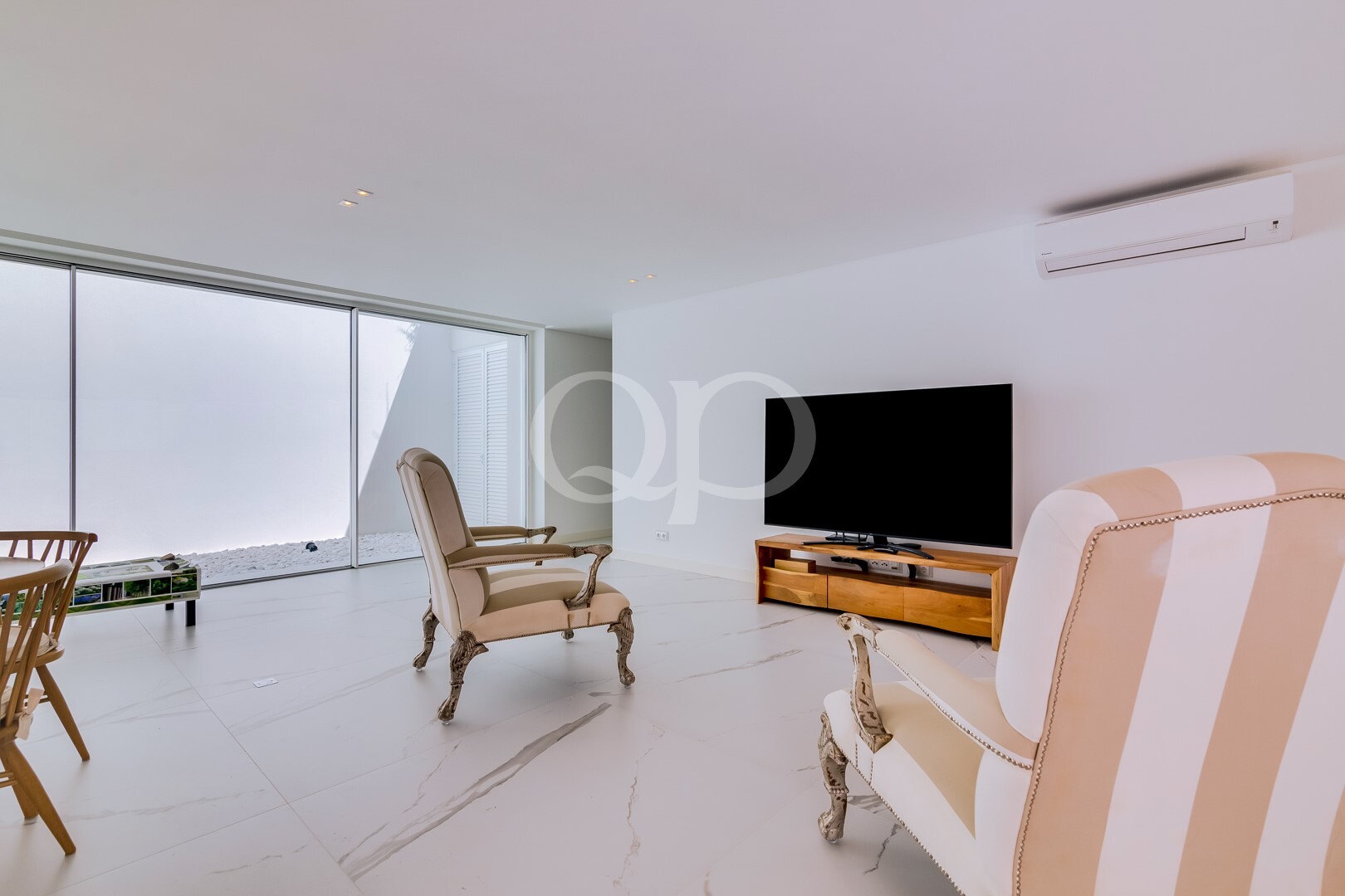 Sitting room with garden views and wall mounted television