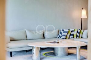 Contemporary sitting area with curved sofa and statement coffee table