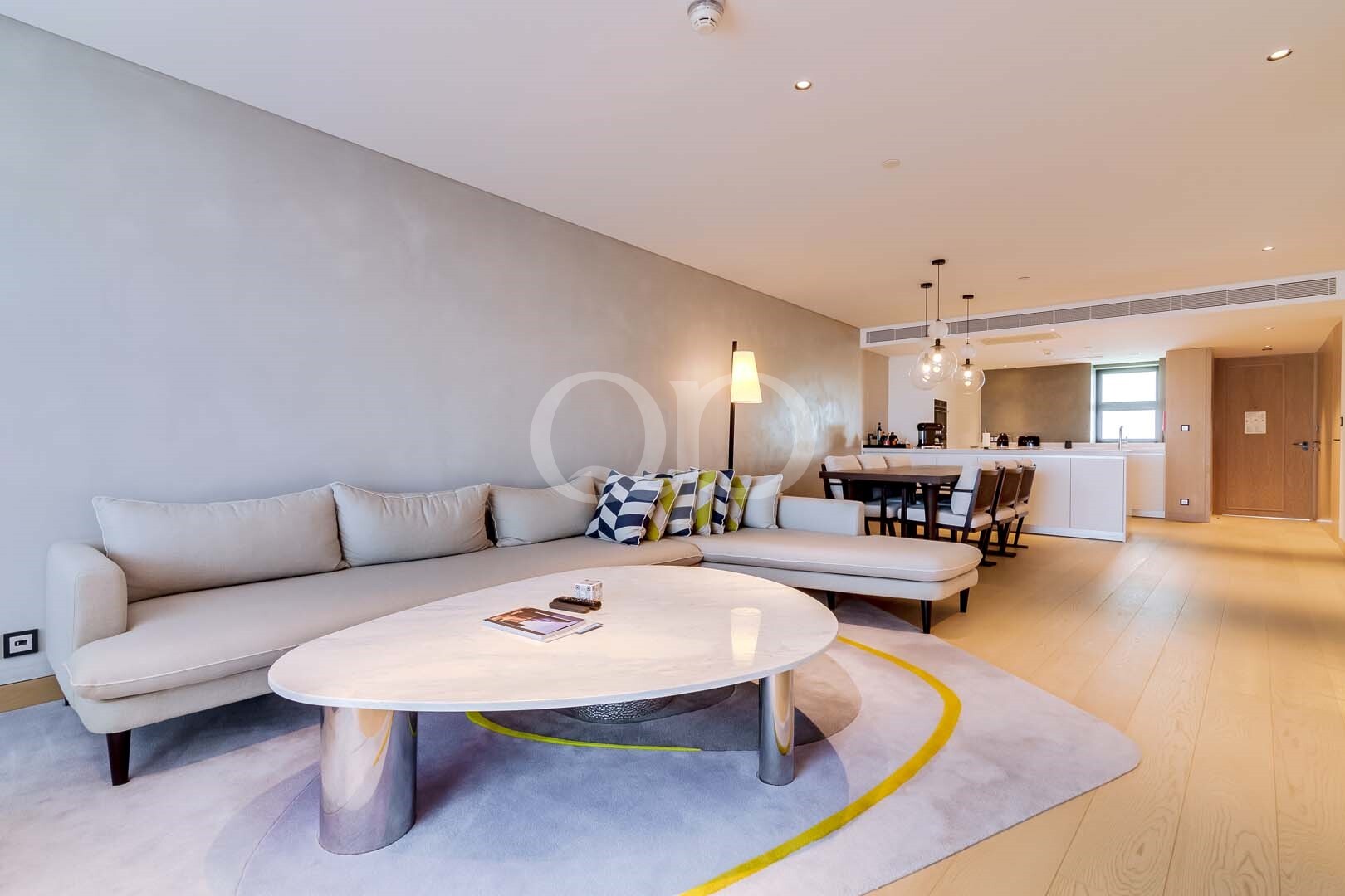 Spacious sitting room with curved sofa and open plan dining area