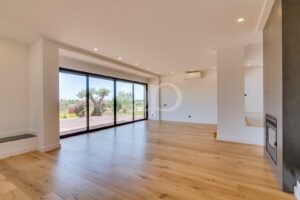 Bright sitting room with floor to ceiling glazing and garden access