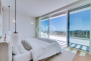 Bright bedroom with floor to ceiling glazing and panoramic Atlantic sea views.
