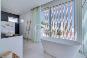 Contemporary ensuite bathroom with modern finishes, architectural windows and abundant natural light.
