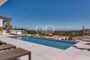 Infinity swimming pool with uninterrupted views across the surrounding countryside and sea.