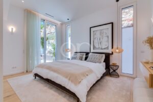Elegant bedroom with contemporary interiors, natural light and peaceful garden views.