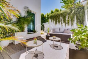 Stylish outdoor lounge surrounded by lush landscaping and a private garden terrace.