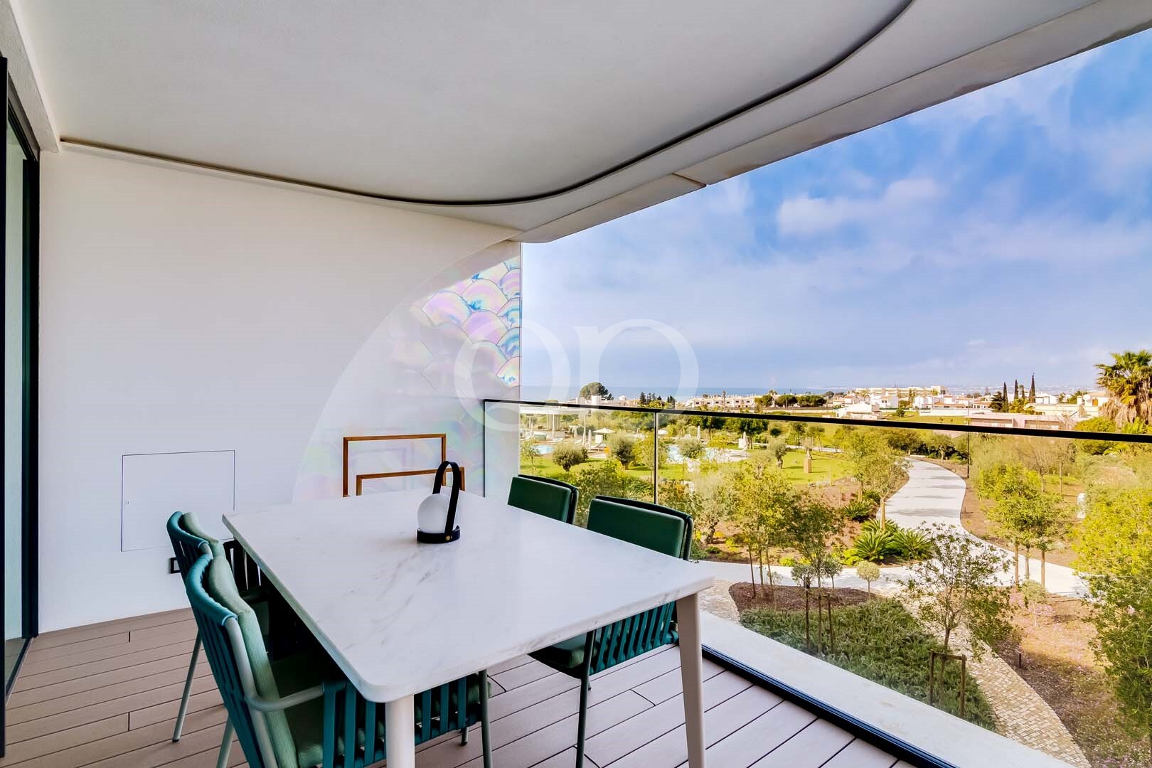 Covered terrace with outdoor dining and panoramic garden views