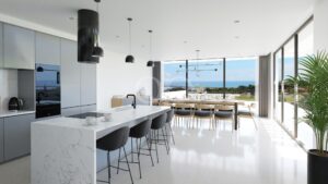 Cozinha e sala de jantar em plano aberto com vistas panorâmicas sobre a costa