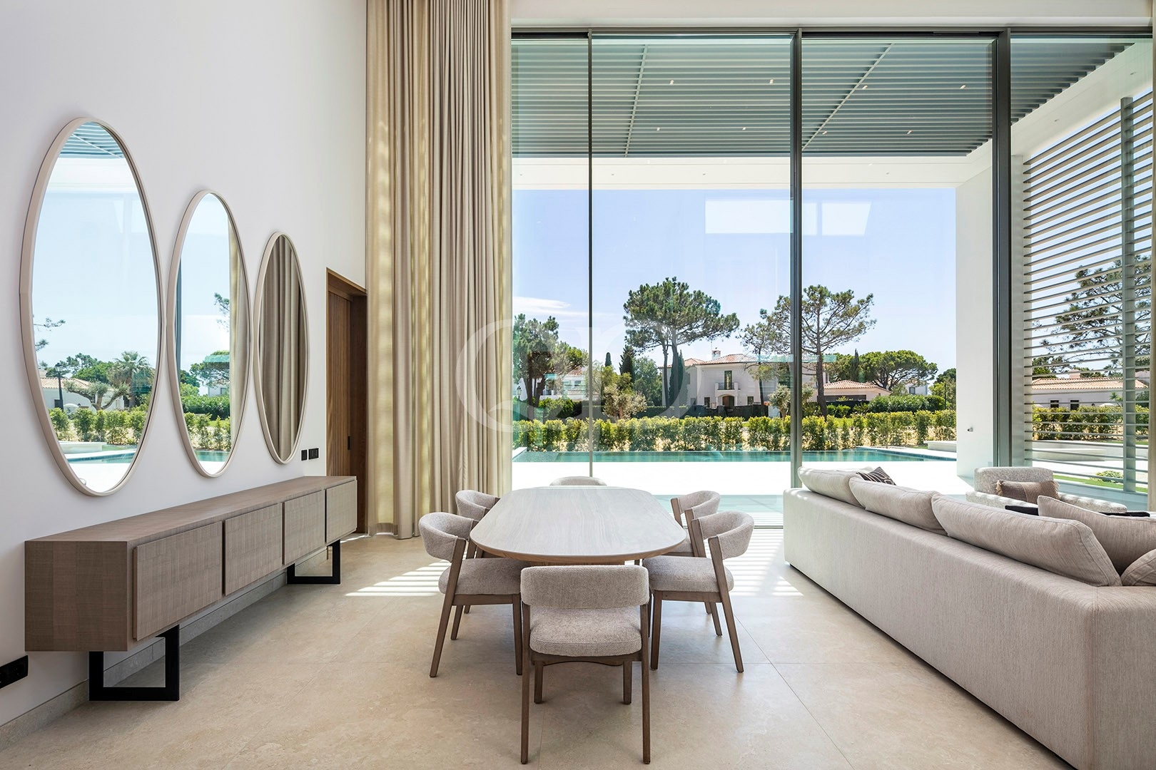 Elegant dining area overlooking swimming pool