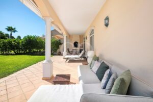 Covered outdoor terrace with garden views