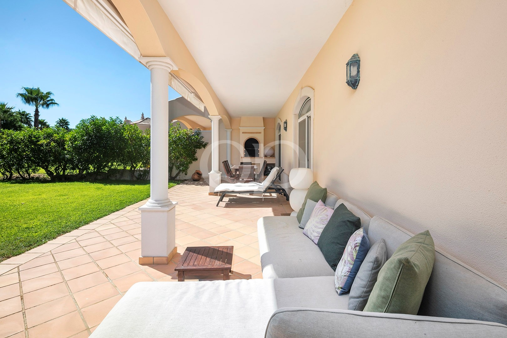 Covered outdoor terrace with garden views