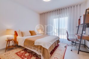 Spacious double bedroom with private balcony access and natural light