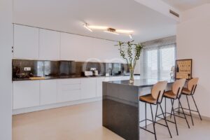Contemporary fully fitted kitchen with island and breakfast seating