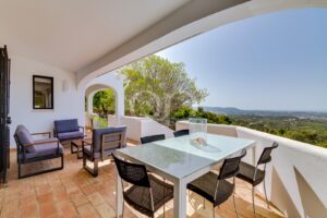 Covered terrace with outdoor dining and panoramic sea views