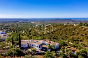 Aerial view of traditional villa surrounded by Algarve countryside