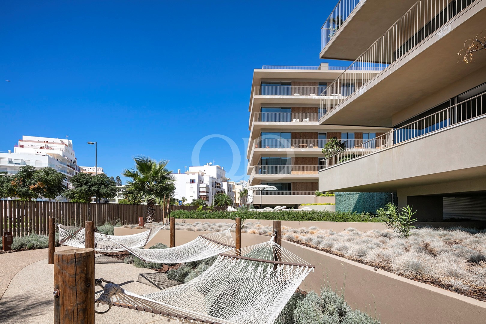 Contemporary apartment building with landscaped gardens and outdoor relaxation areas