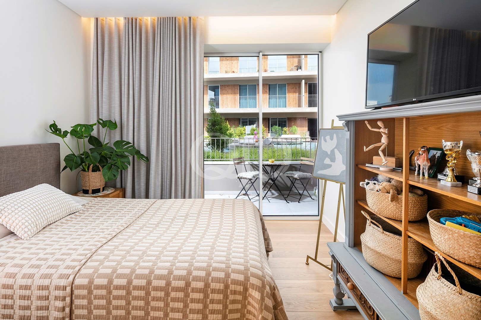 Bright bedroom with private balcony access and contemporary neutral interiors