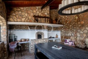 Rustic stone interior with traditional fireplace and exposed stone walls